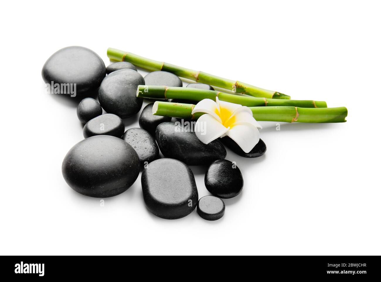 Spa stones, flower and bamboo on white background Stock Photo - Alamy