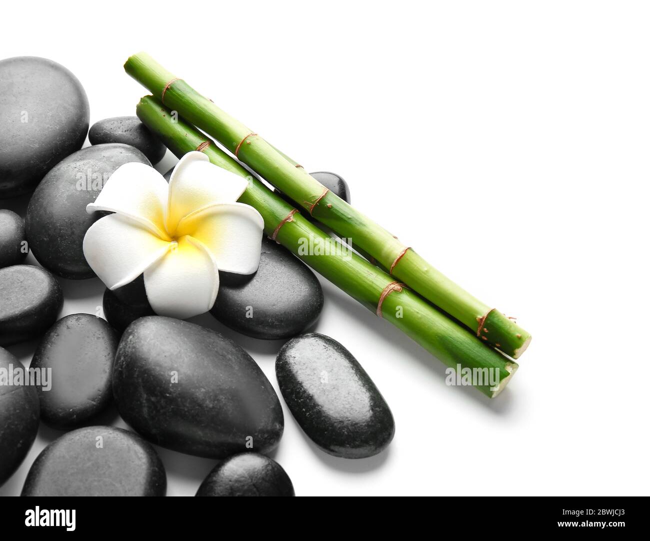 Spa stones, flower and bamboo on white background Stock Photo - Alamy