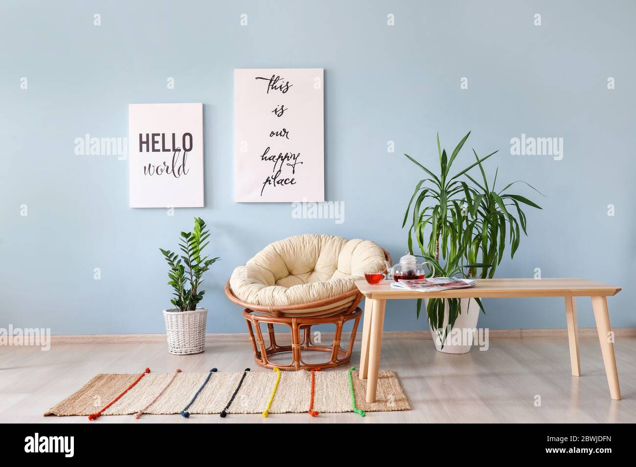 Interior of modern room with comfortable armchair and table Stock Photo ...