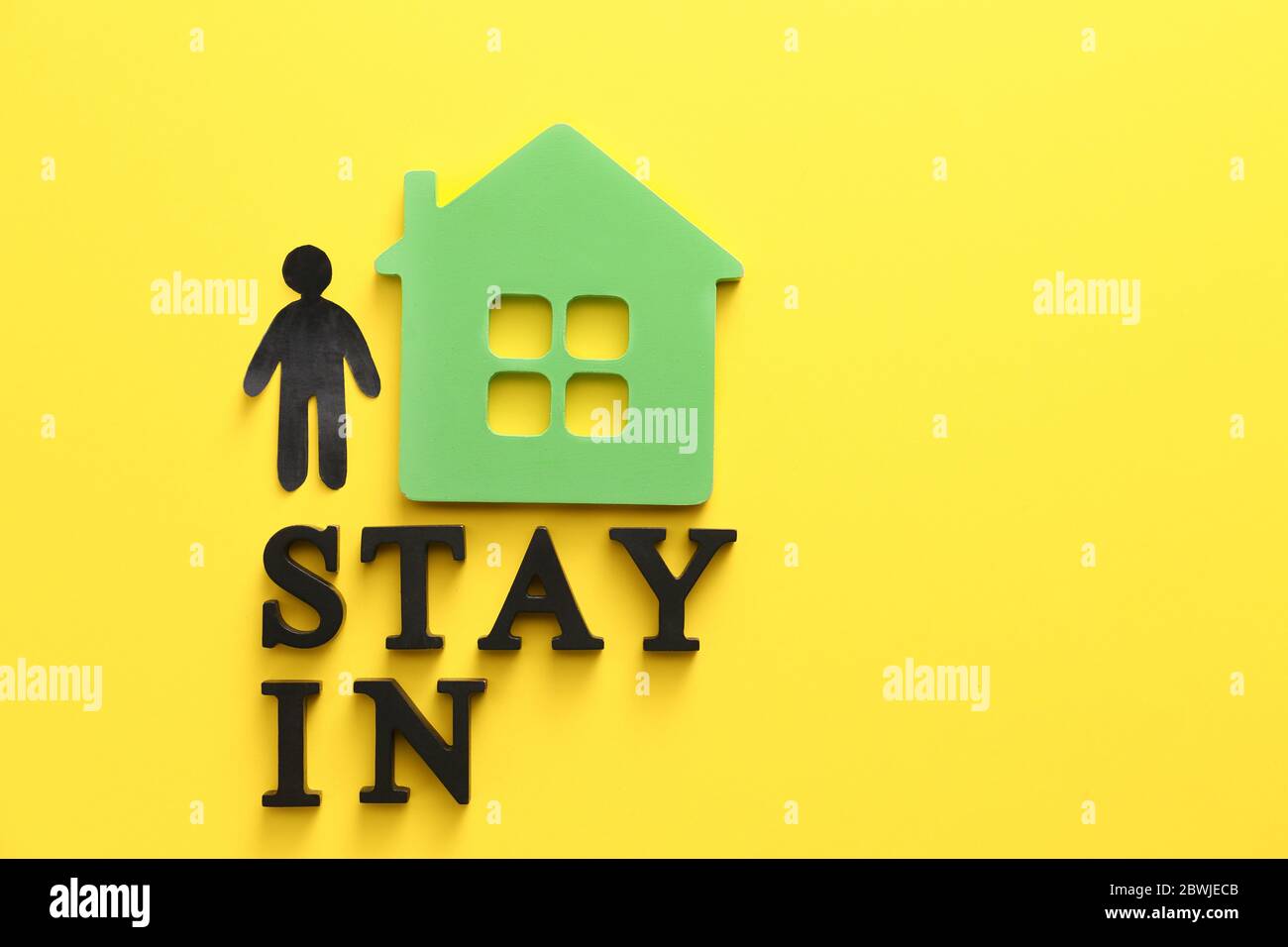 Human figure with model of house and text STAY IN on color background ...