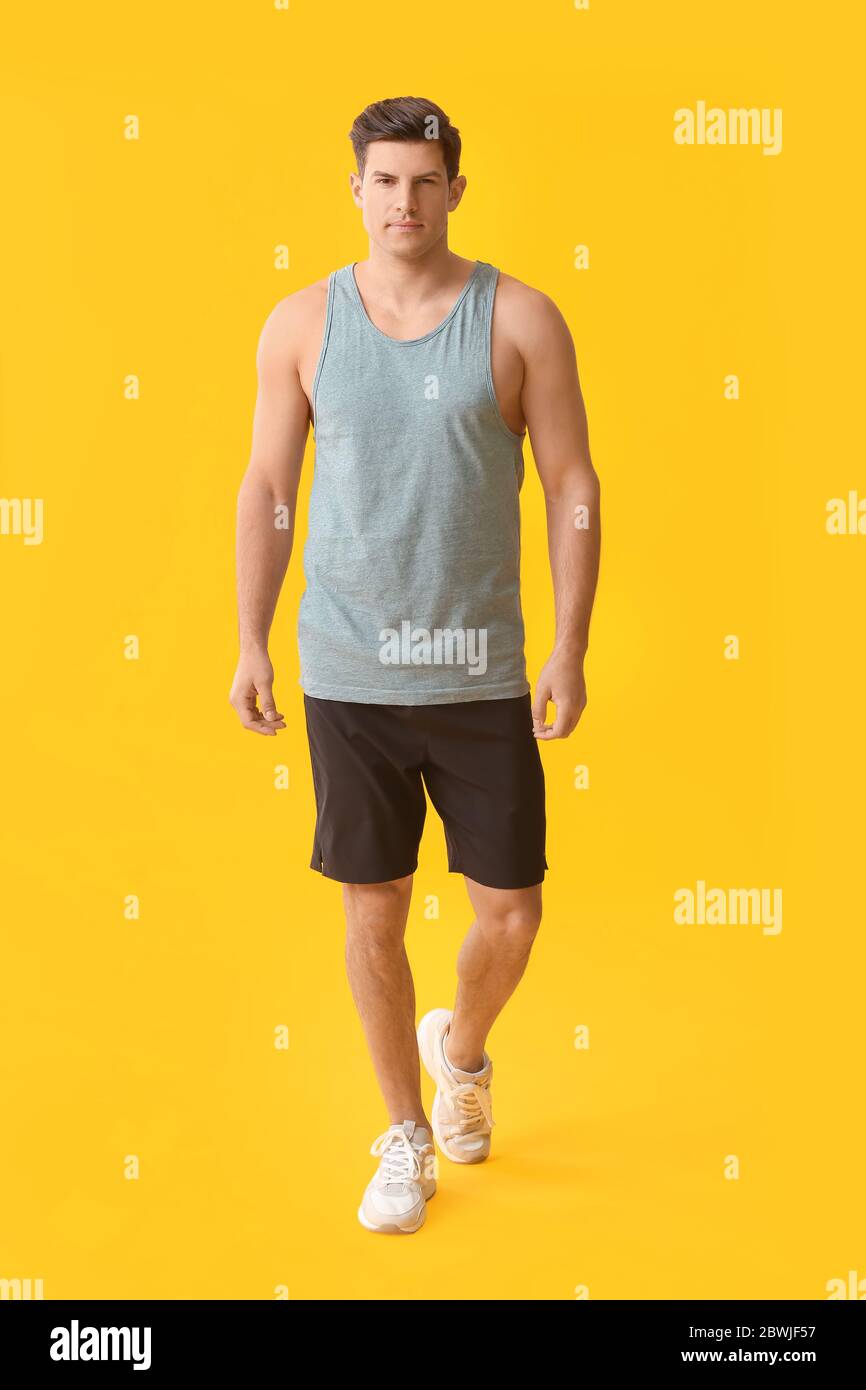 Sporty young man on color background Stock Photo - Alamy