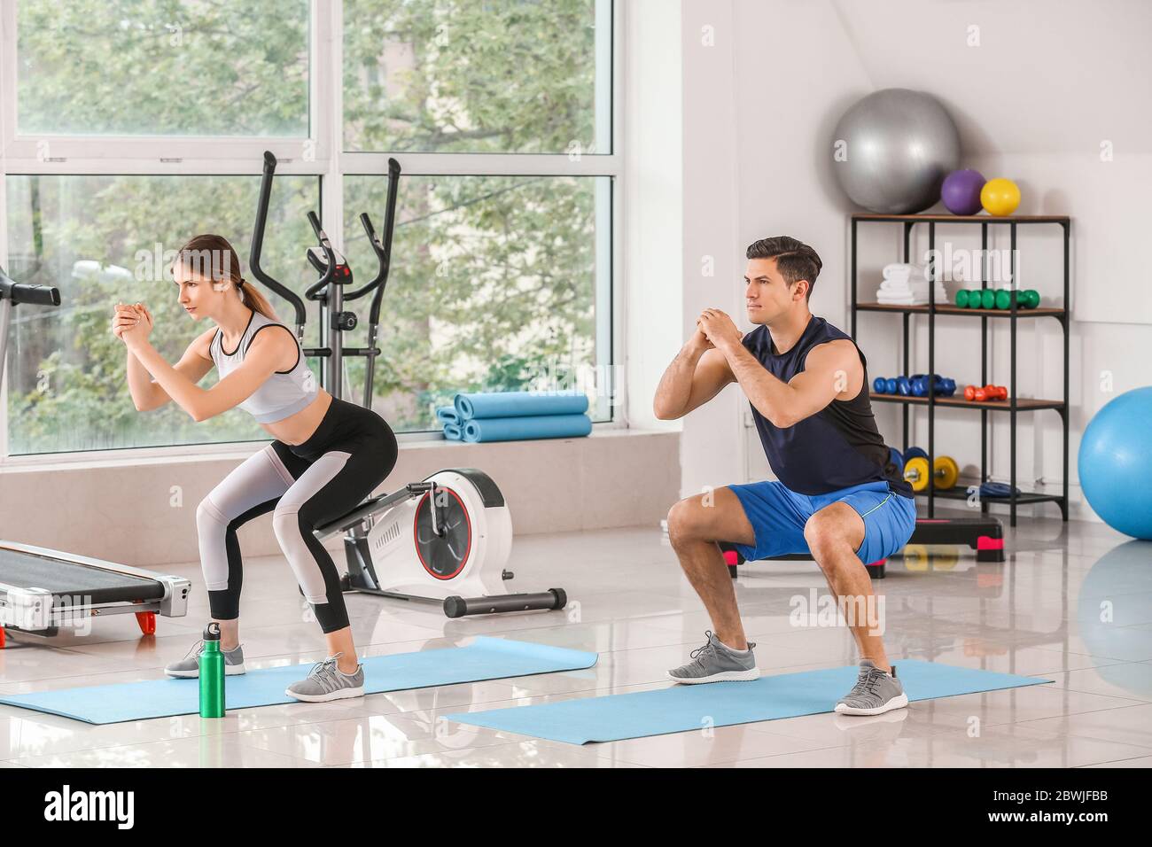 Sporty young couple training in gym Stock Photo - Alamy