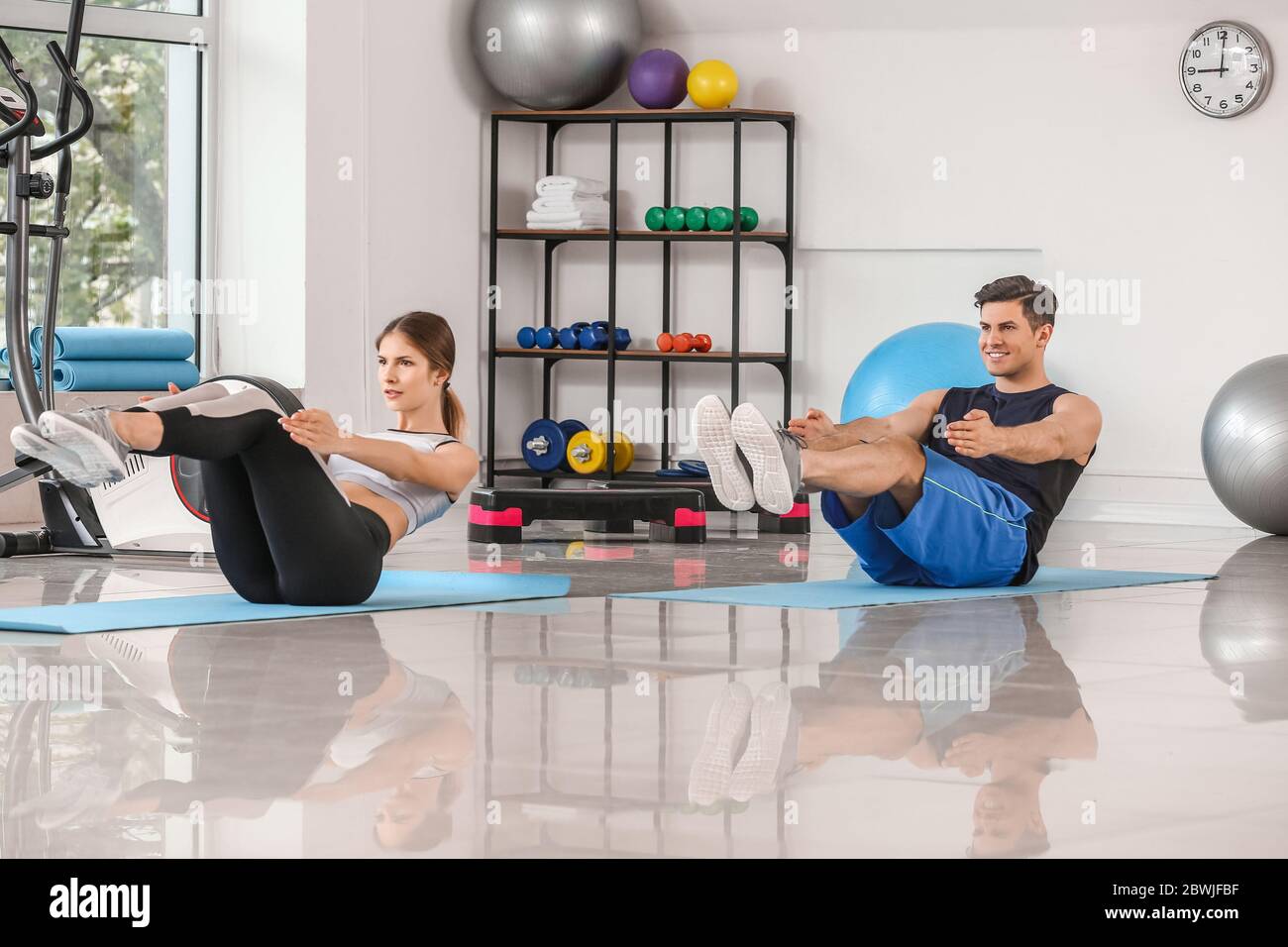 Sporty young couple training in gym Stock Photo - Alamy