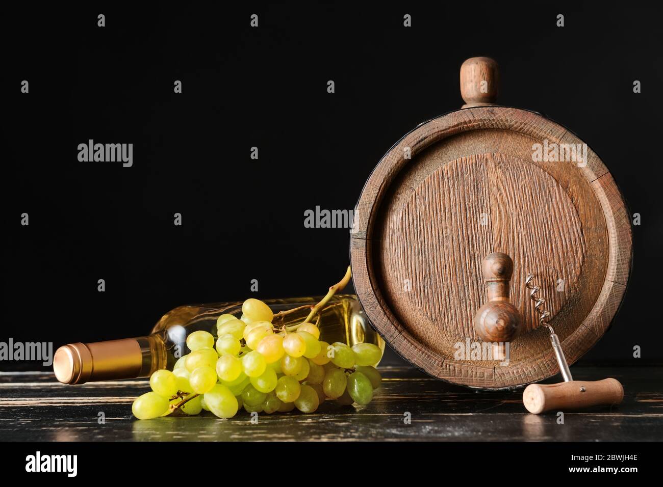 Wooden barrel and bottle of wine on dark background Stock Photo - Alamy
