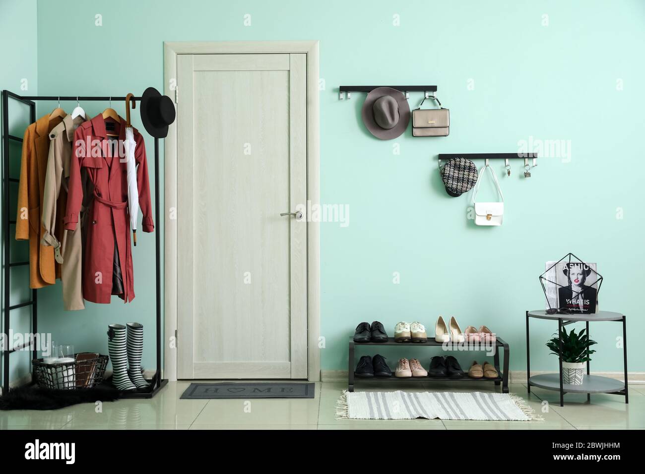 Stylish interior of modern hall with shoes on stand Stock Photo - Alamy