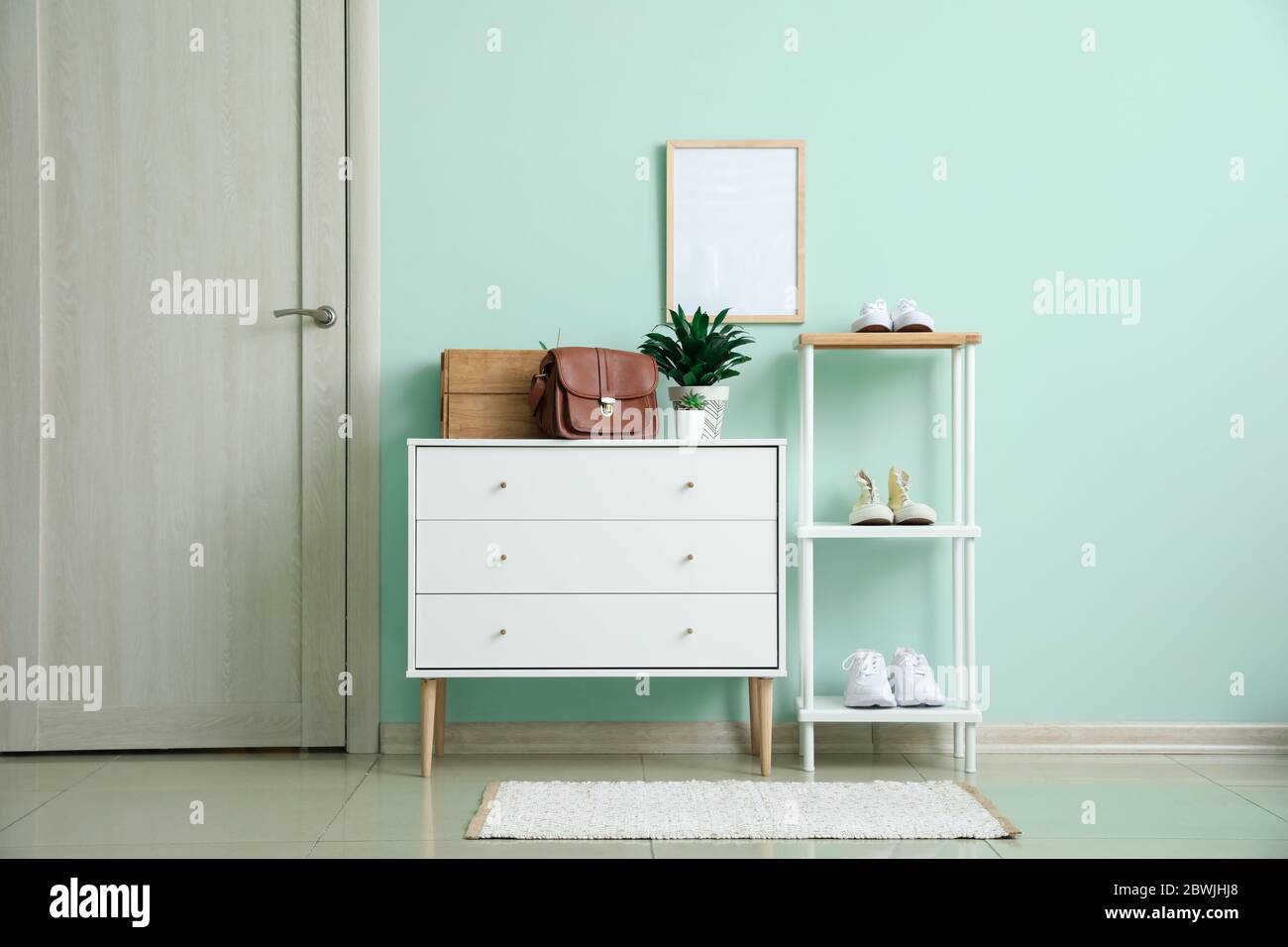Stylish interior of modern hall with shoes on stand Stock Photo - Alamy