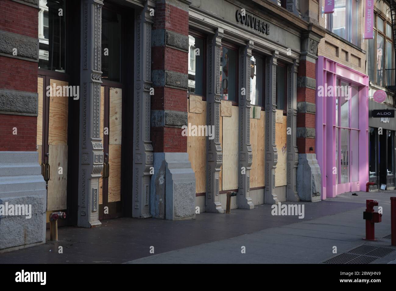 New York, NY, USA - June 1, 2020: Shop windows boarded up on Broadway and Prince Street in New York City after 2 nights of looting Stock Photo
