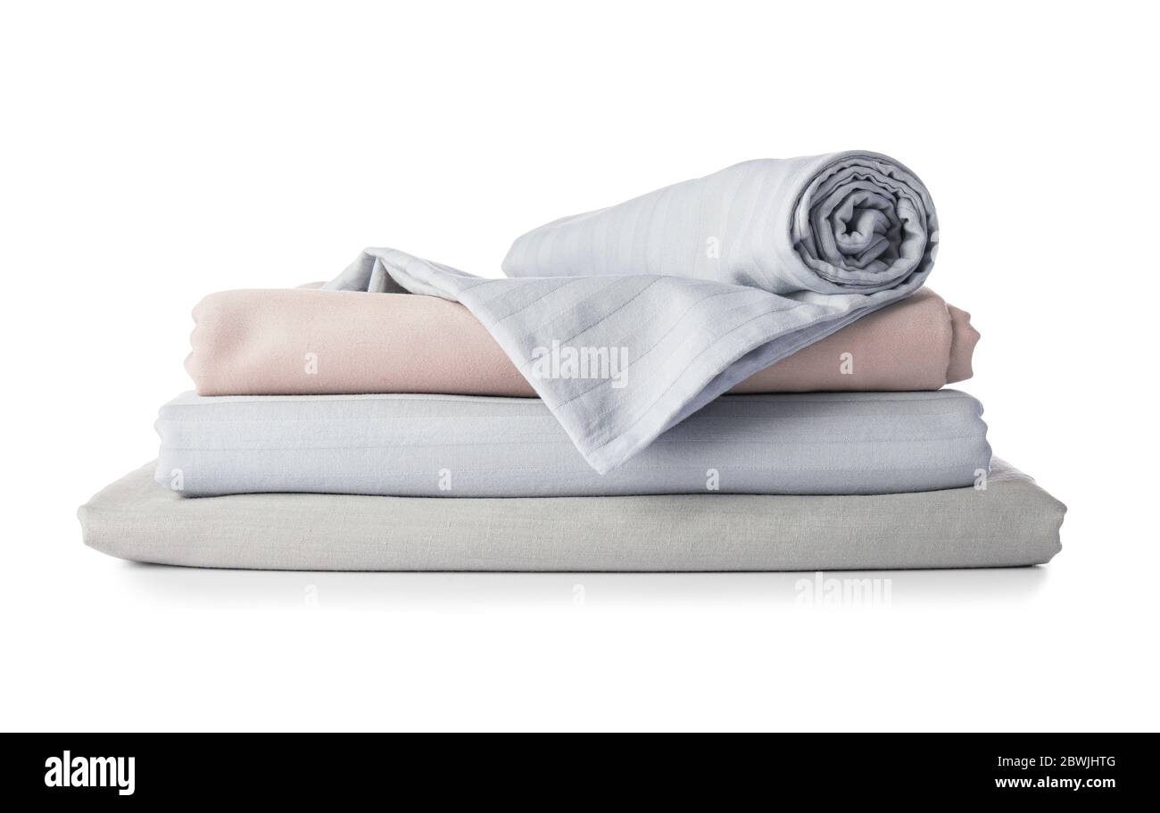 Stack of clean bed sheets on white background Stock Photo