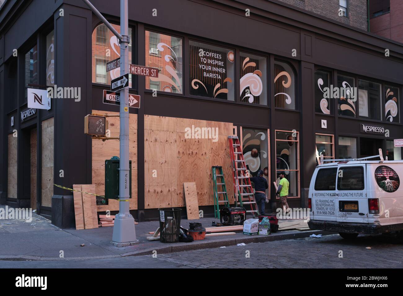 New York, NY, USA - June 1, 2020: Workers board up the Nespresso coffee shop windows on Prince Street in New York City of looting Stock Photo Alamy