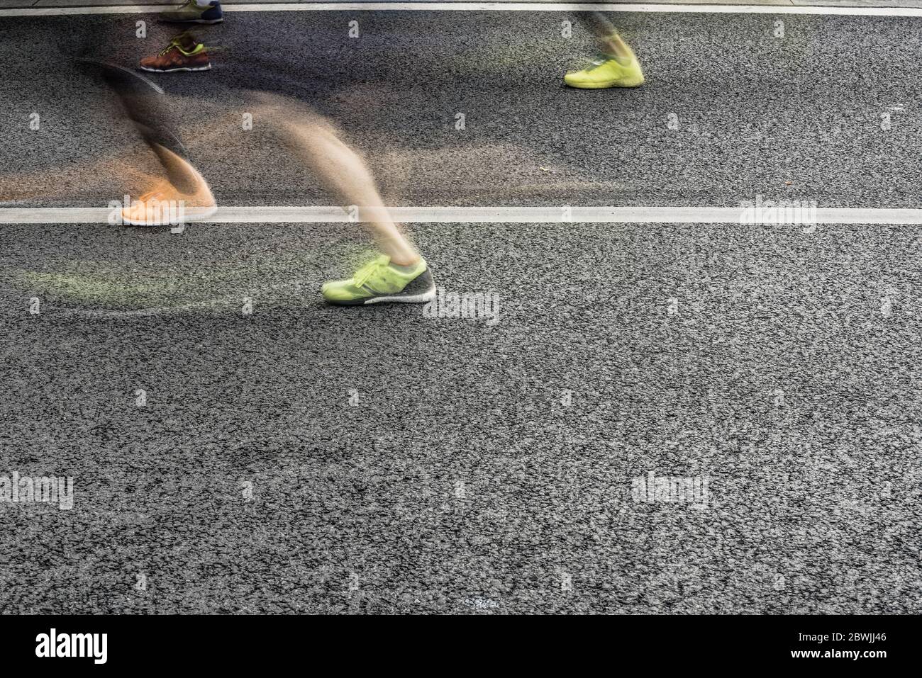 People running in marathon on city streets. Motion blur. Stock Photo