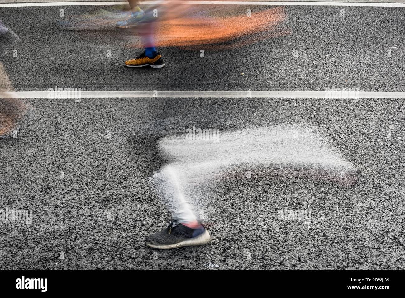 People running in marathon on city streets. Motion blur. Stock Photo