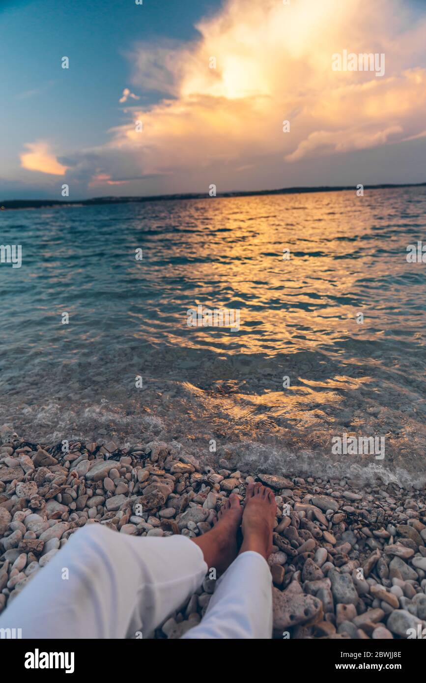 woman laying at the beach looking on sunset above sea Stock Photo - Alamy