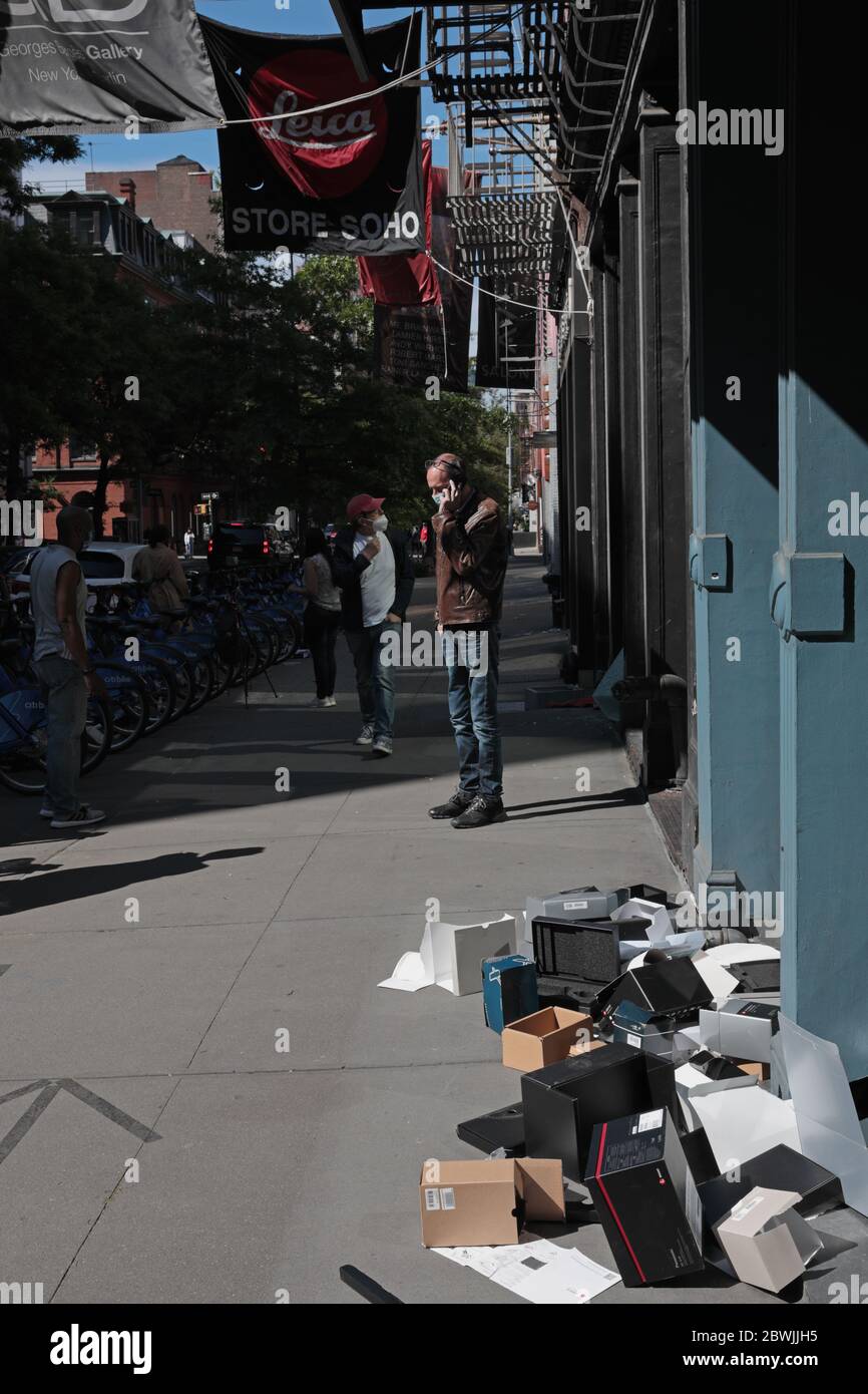 New York, NY, USA - June 1, 2020: Empty camera and lens boxes on the sidewalk outside the Leica store on West Broadway windows smashed and looted Stock Photo