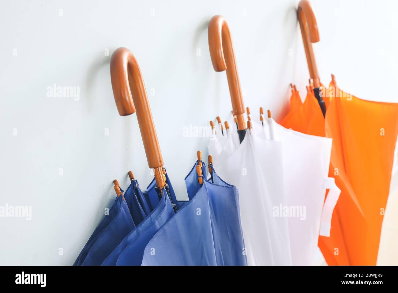 Stylish umbrellas on color background Stock Photo