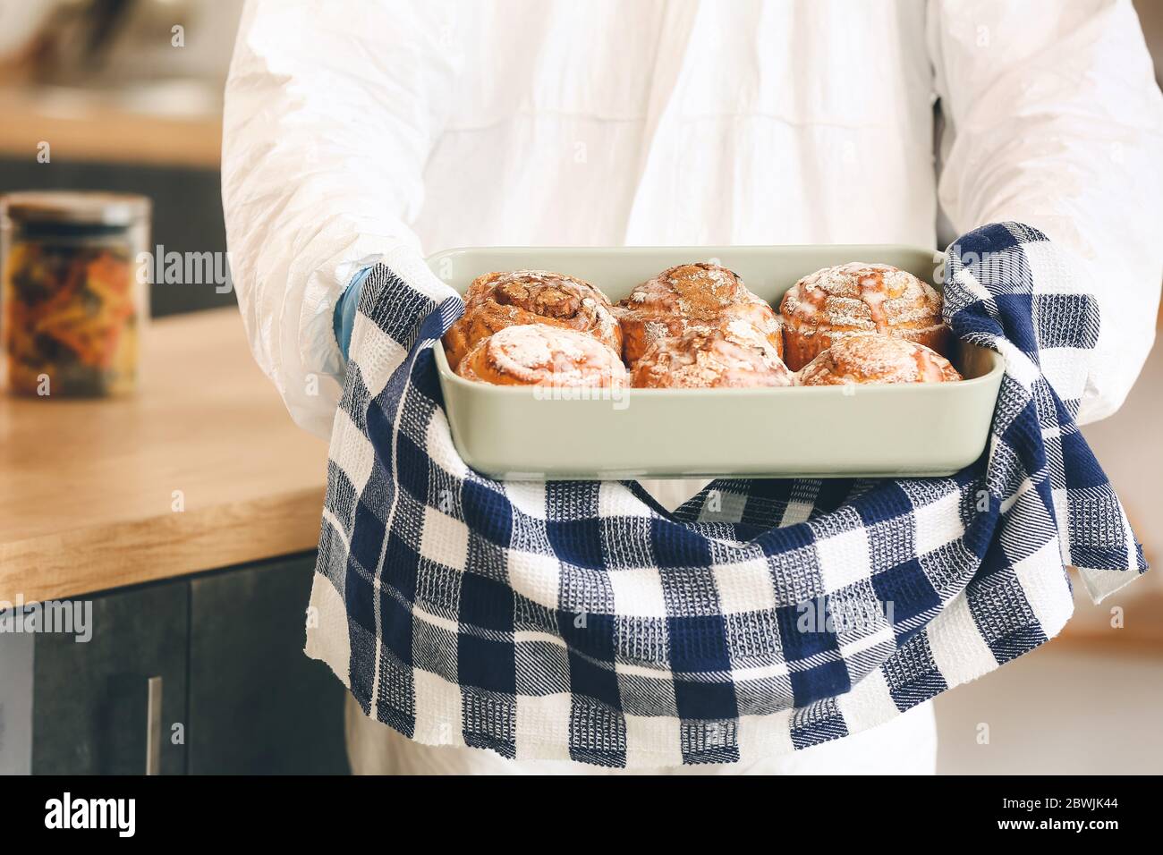 Woman in biohazard suit cooking in kitchen Stock Photo - Alamy