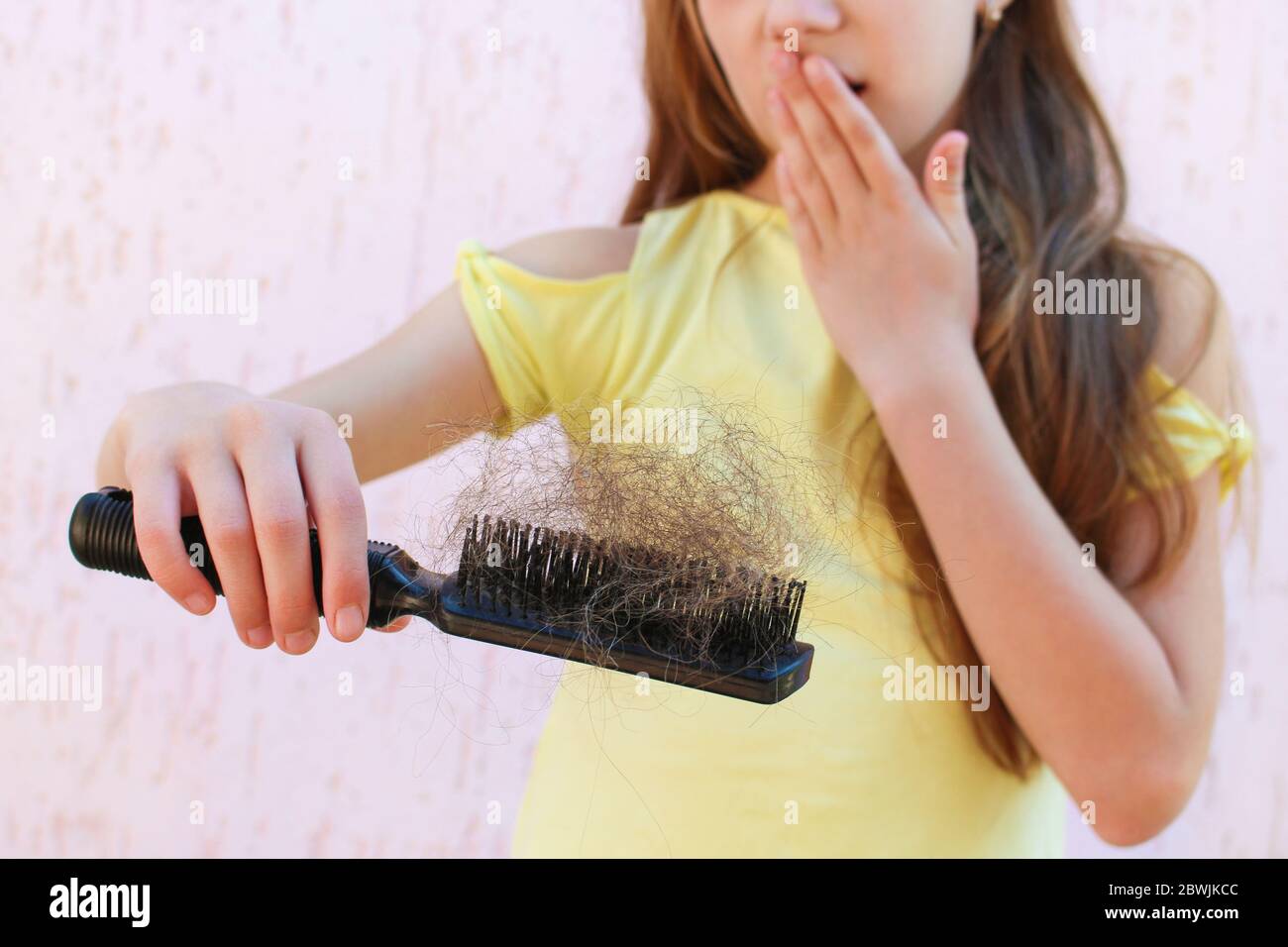 Girl is shocked by amount of hair that has fallen out Stock Photo Alamy
