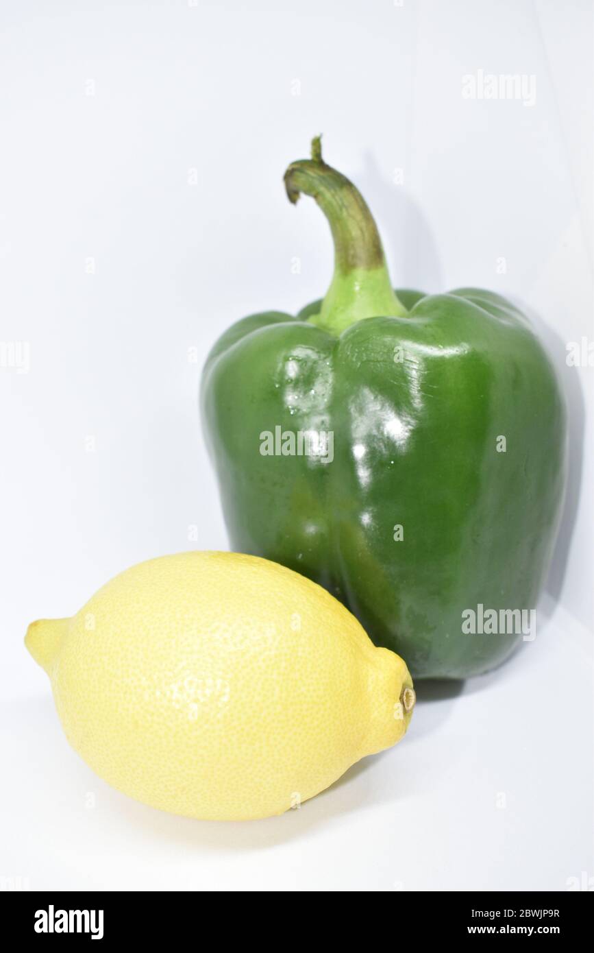 Capsicum and lemon isolated on white background Stock Photo - Alamy