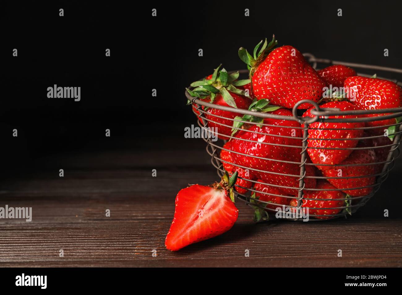 Basket with ripe strawberry on dark background Stock Photo - Alamy