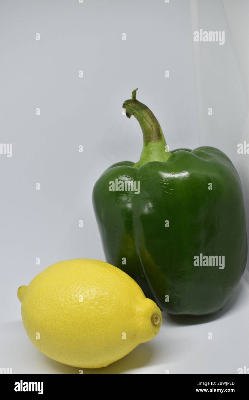 Capsicum and lemon isolated on white background Stock Photo - Alamy