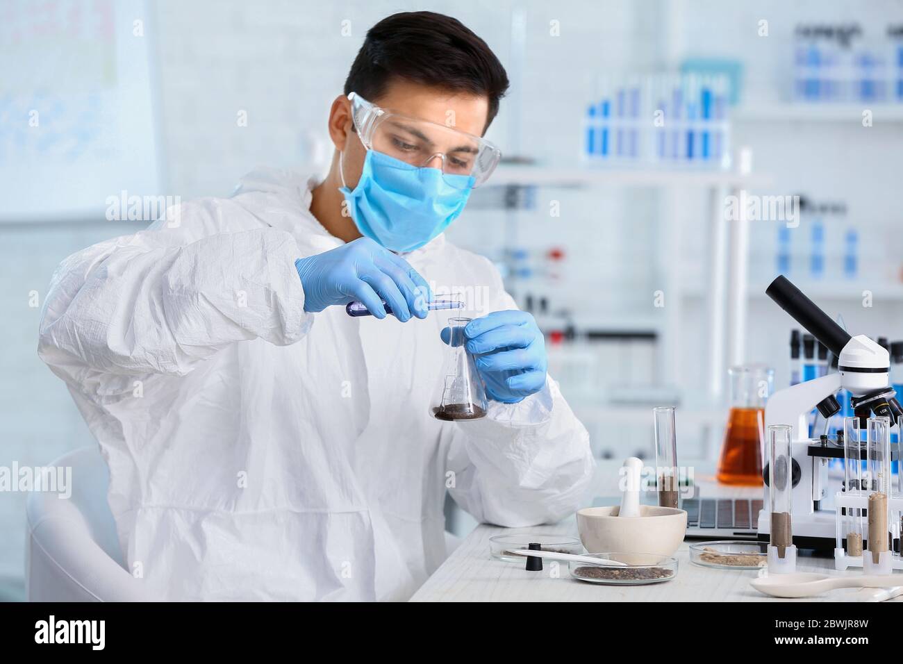 Scientist studying samples of soil in laboratory Stock Photo - Alamy