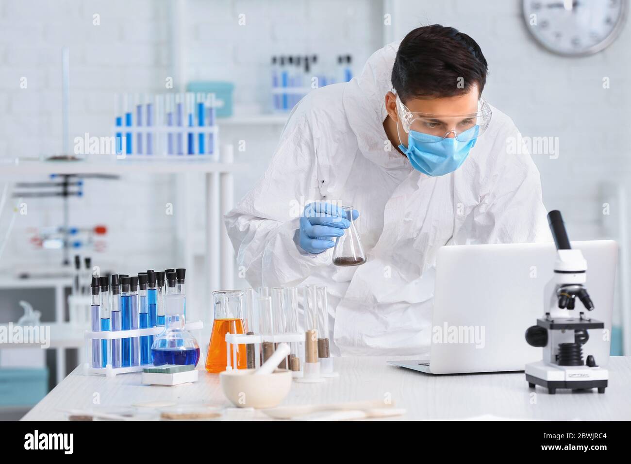 Scientist studying samples of soil in laboratory Stock Photo - Alamy