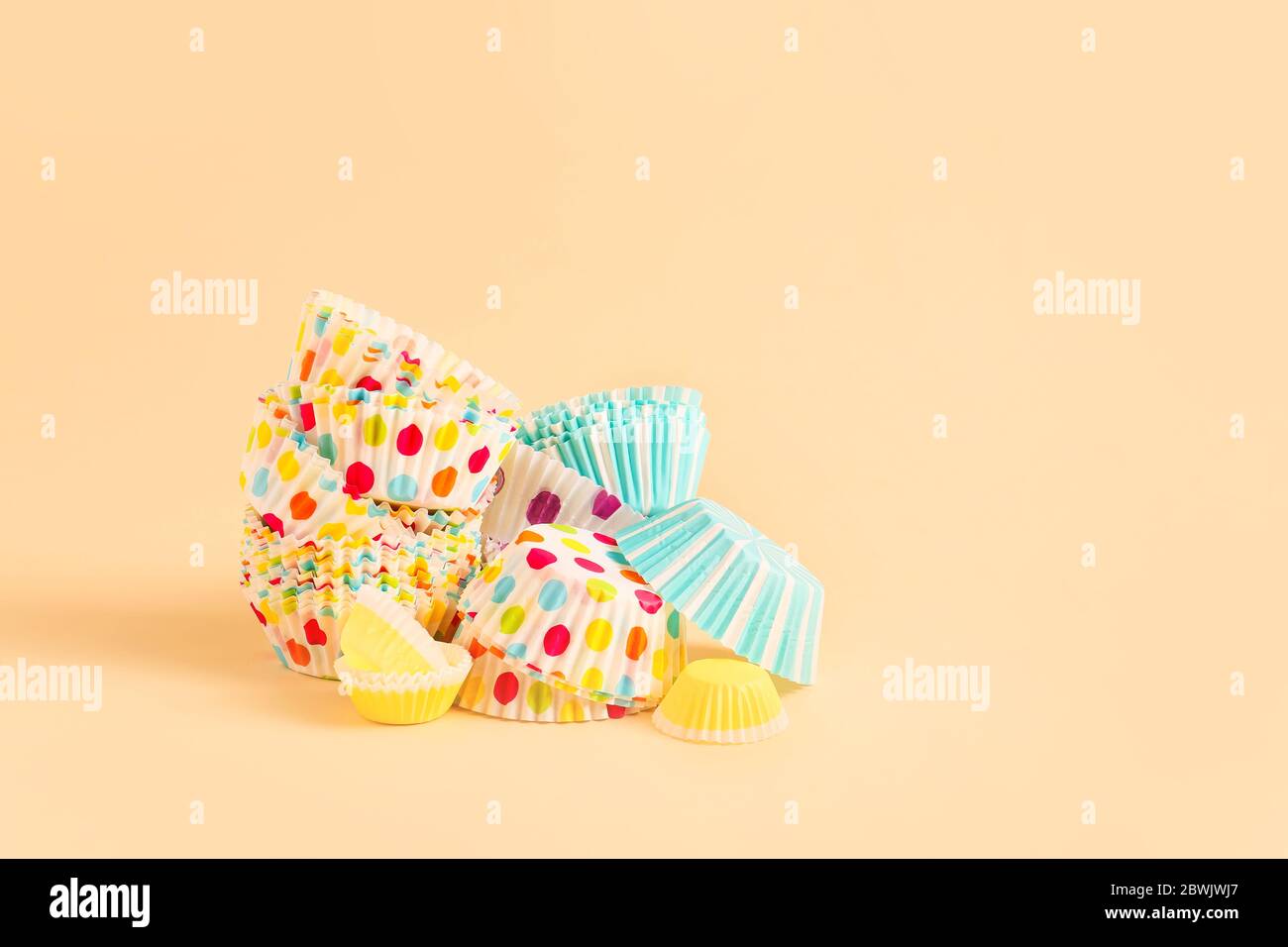Muffin baking cups on color background Stock Photo