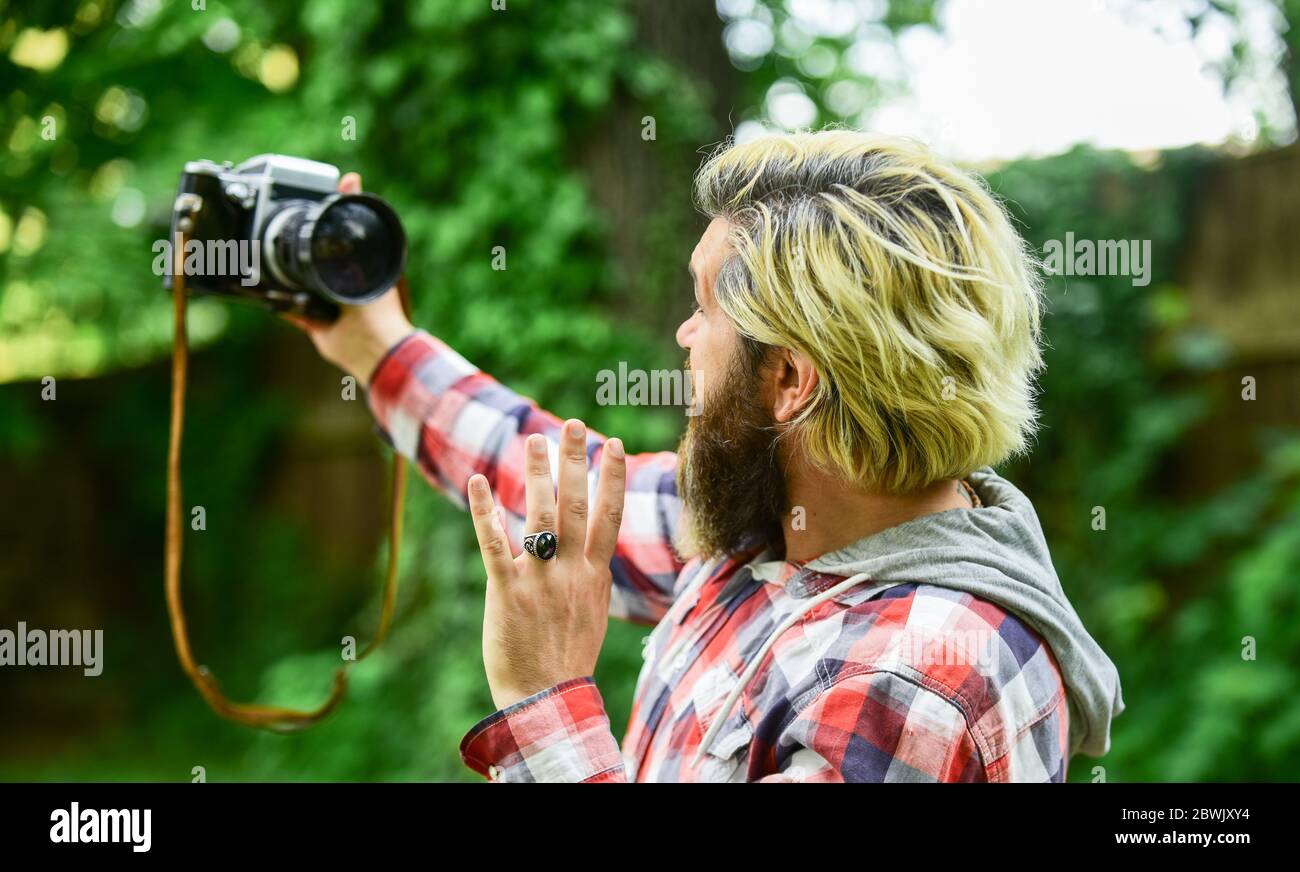 capture these memories. SLR camera. hipster man with beard use professional camera. selfie time. photographer hold retro camera. journalist is my career. reporter make photo. vintage camera. Stock Photo