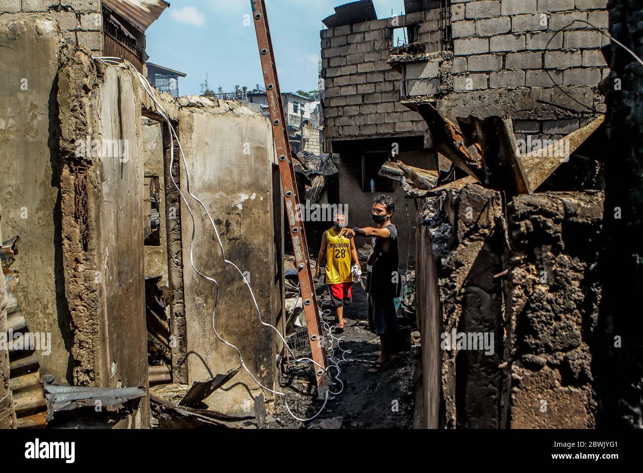 Manila. 2nd June, 2020. Residents look for their belongings from their charred home after a fire at a residential area in Manila, the Philippines on June 2, 2020. Credit: Rouelle Umali/Xinhua/Alamy Live News Stock Photo