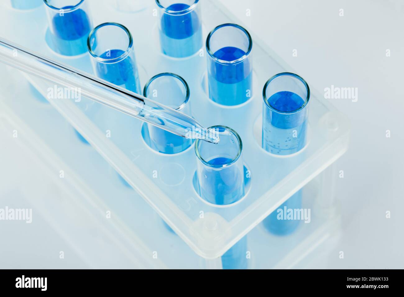Sample Lab Dripper Laboratory glassware with a dropper dripping liquid into a test tube ...