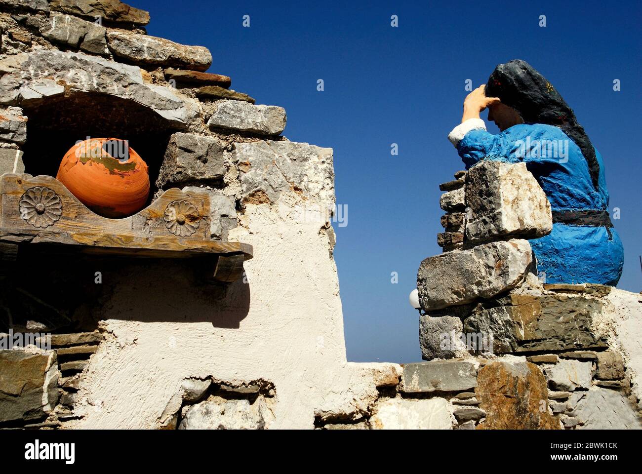 Greece, Karpathos island, statue of woman dressed with traditional costume at the port of Diafani, August 16 2008. Stock Photo