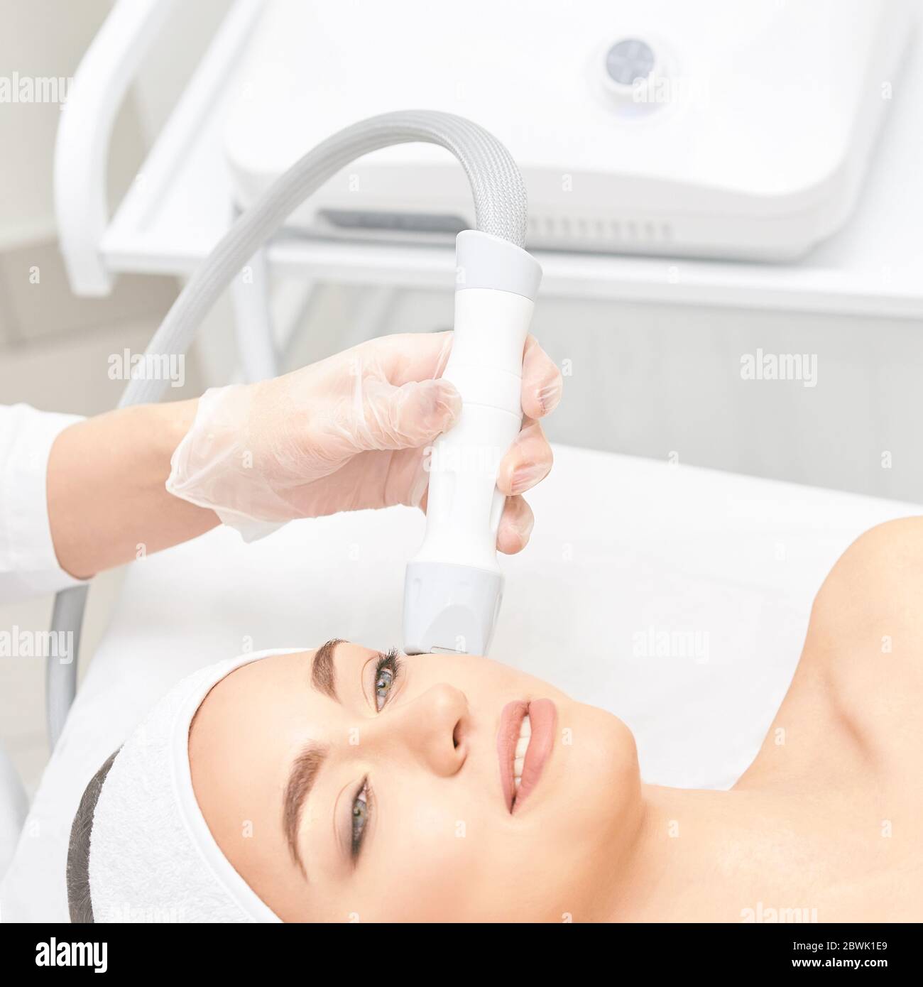 Vacuum face cosmetology equipment. Facial salon cleaning. Youn girl