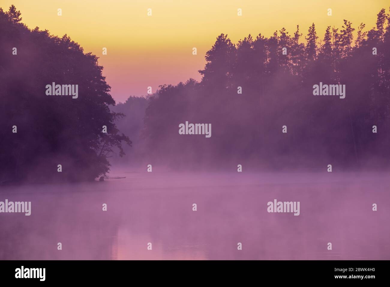 Magical sunrise over the lake. Serene lake in the early misty morning ...