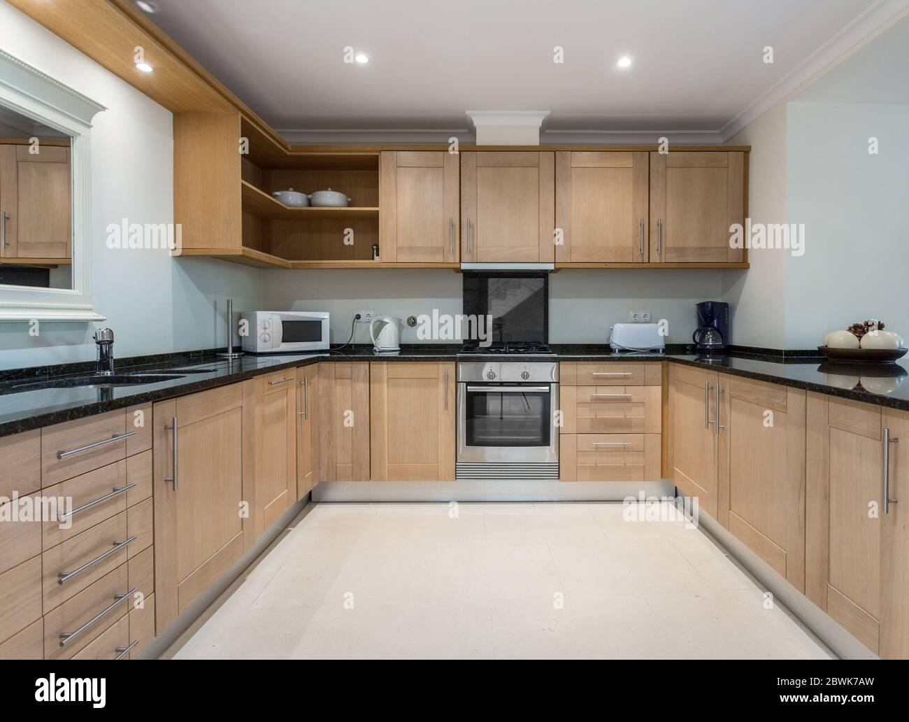 Modern wooden, brown kitchen with electrical appliances. European hotel