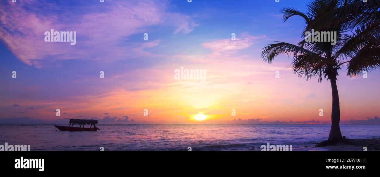 Art beautiful sunrise Landscape of paradise tropical island beach. Palm tree and fishing boat Stock Photo