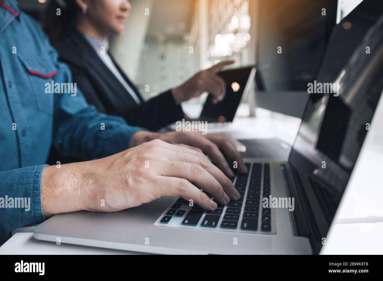 Professional development programmer cooperating meeting programming website working a software in office room. Stock Photo