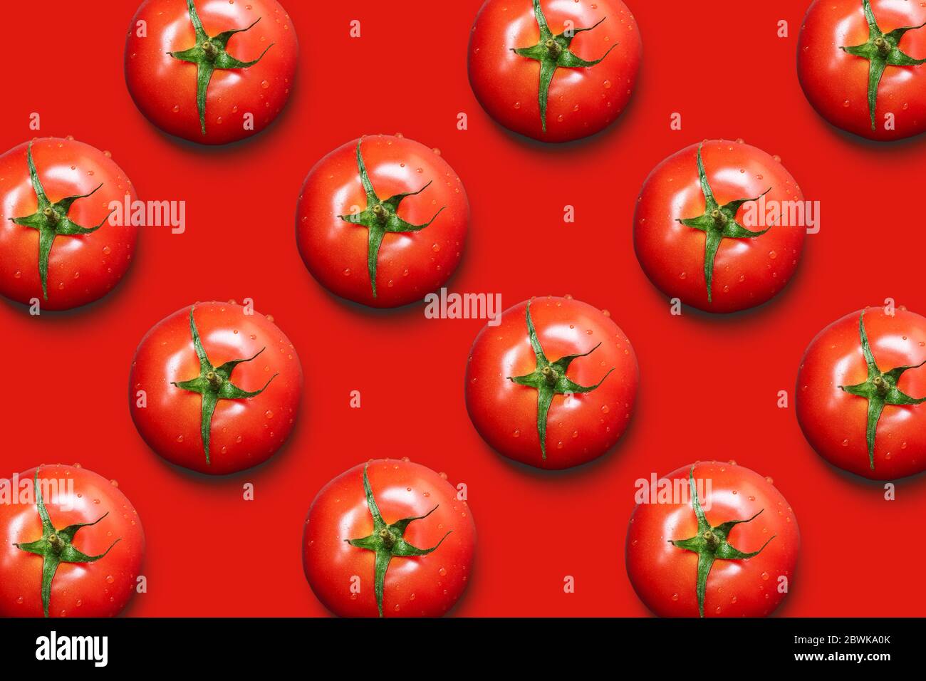Fresh tomatoes isolated on red background. Top view. Stock Photo