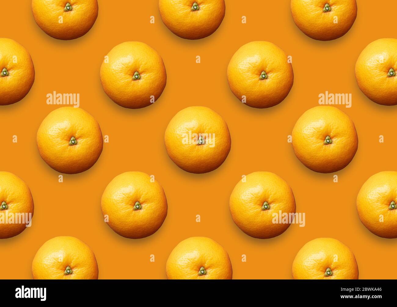 Whole fresh oranges on orange background. Set of colorful citrus fruit pattern. Stock Photo