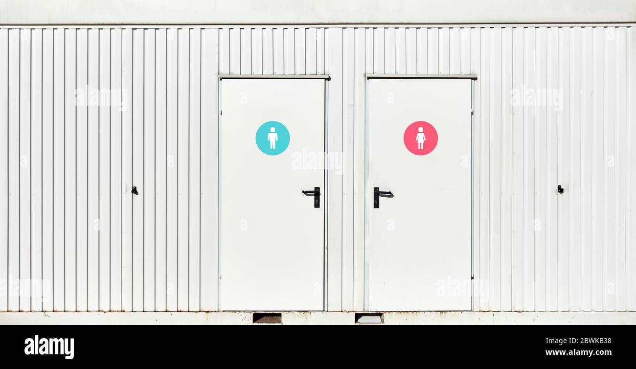 Public toilet with door icons for women and men at the entrance Stock Photo
