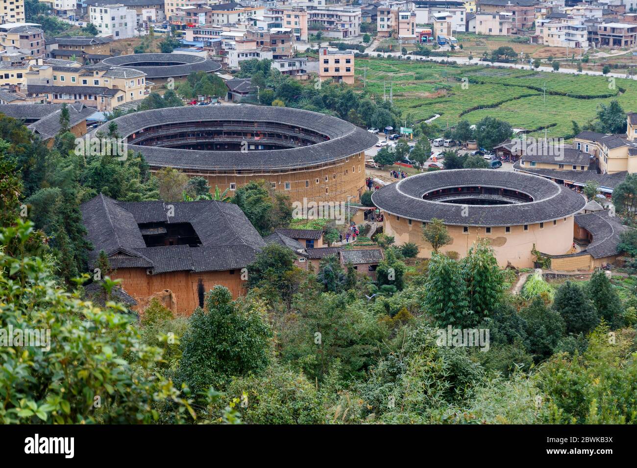High angle view of three Fujian Tulou. The Chinese expression of the traditional houses is 福建土楼 - literally translated 'Fujian earthen buildings'. Stock Photo