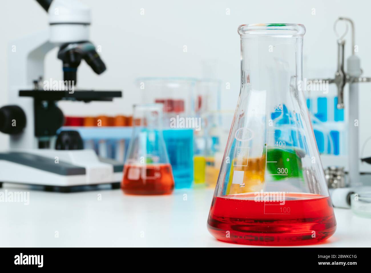 Scientific laboratory with microscope and test tubes with samples ...