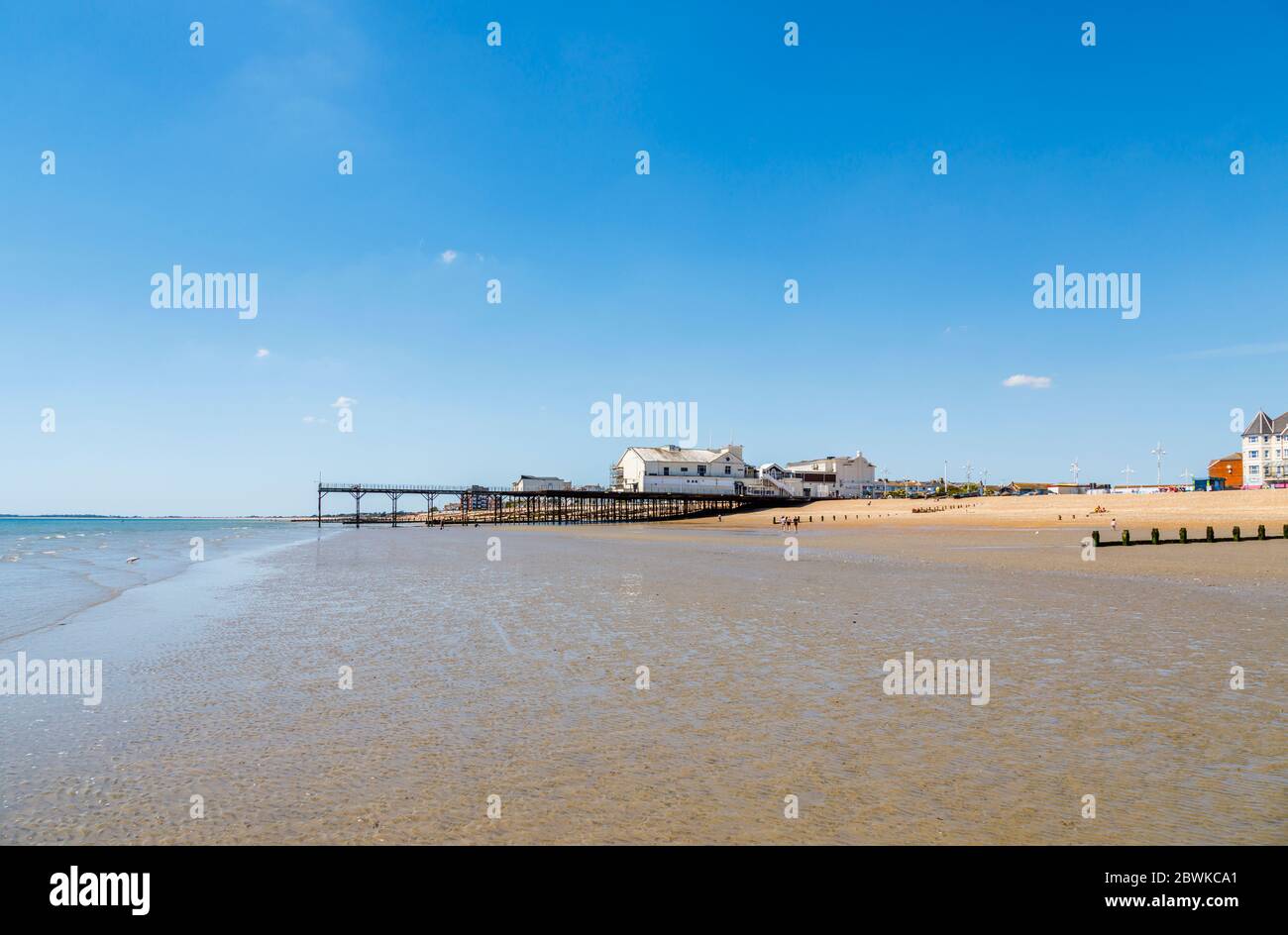 The pier and part sandy part stony shingle beach on the seafront at Bognor Regis, a seaside town