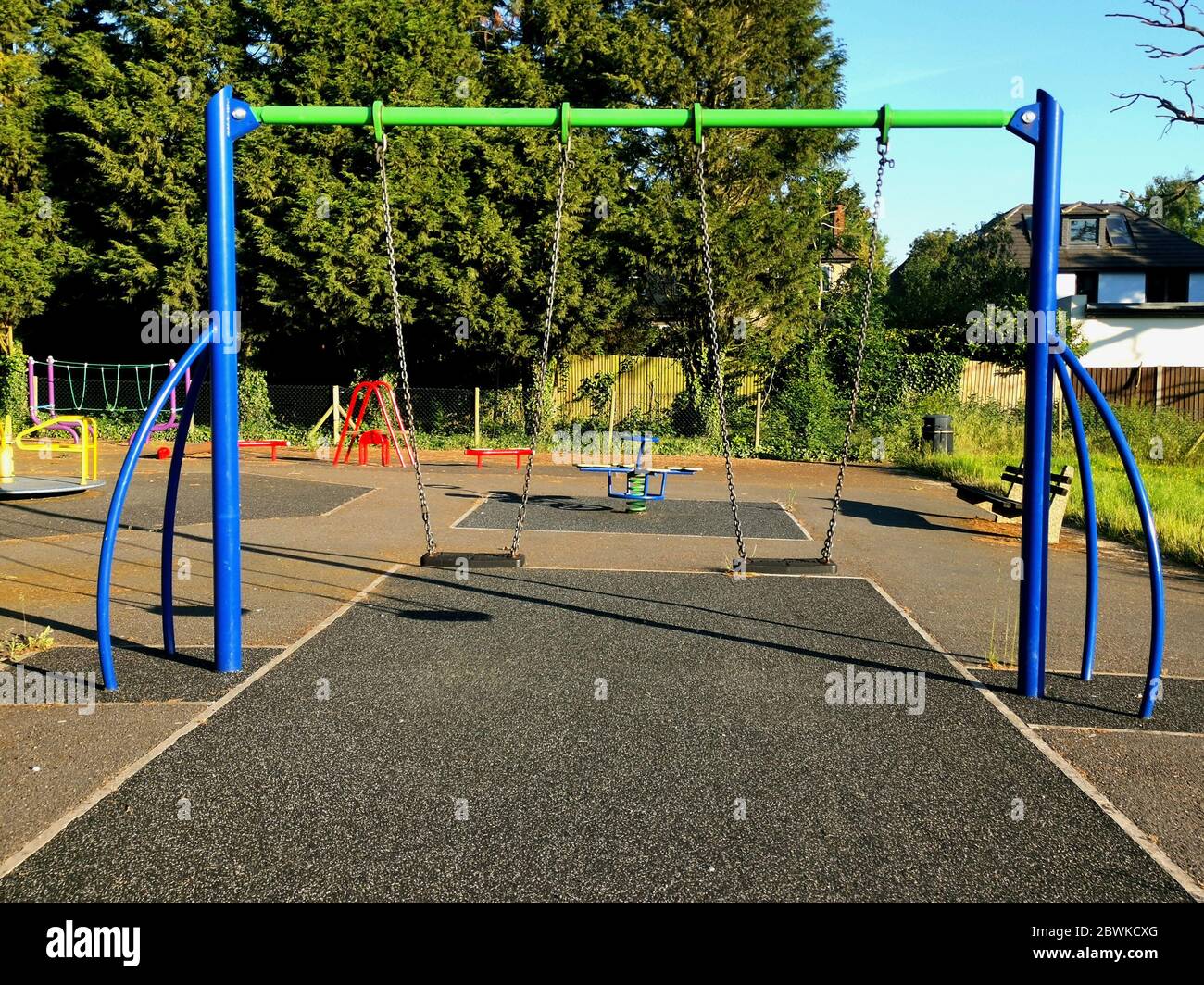 Colourful children's swings and play equipment in local municipal park Stock Photo