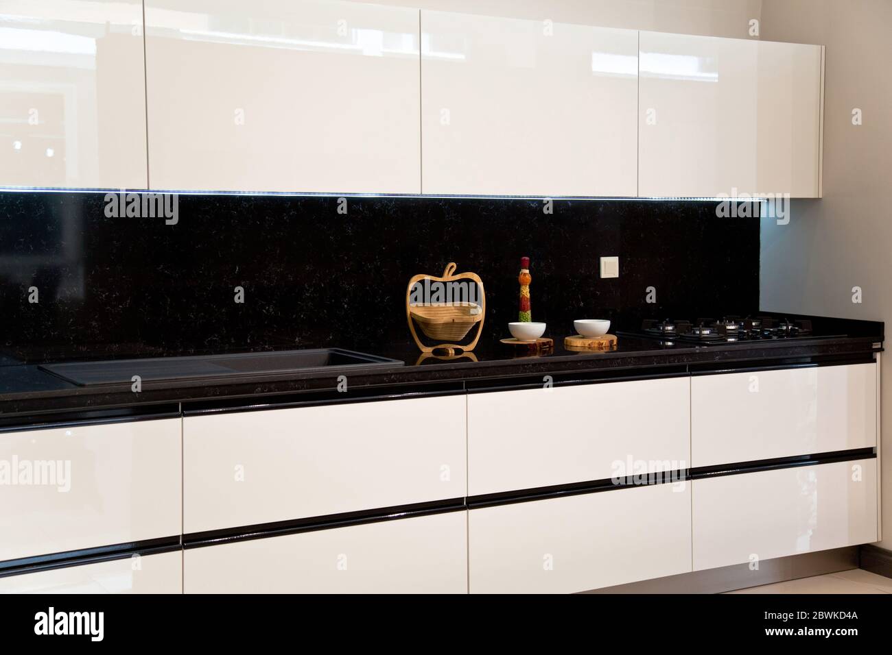 Interior of luxurious modern kitchen, white cabinets and black ...