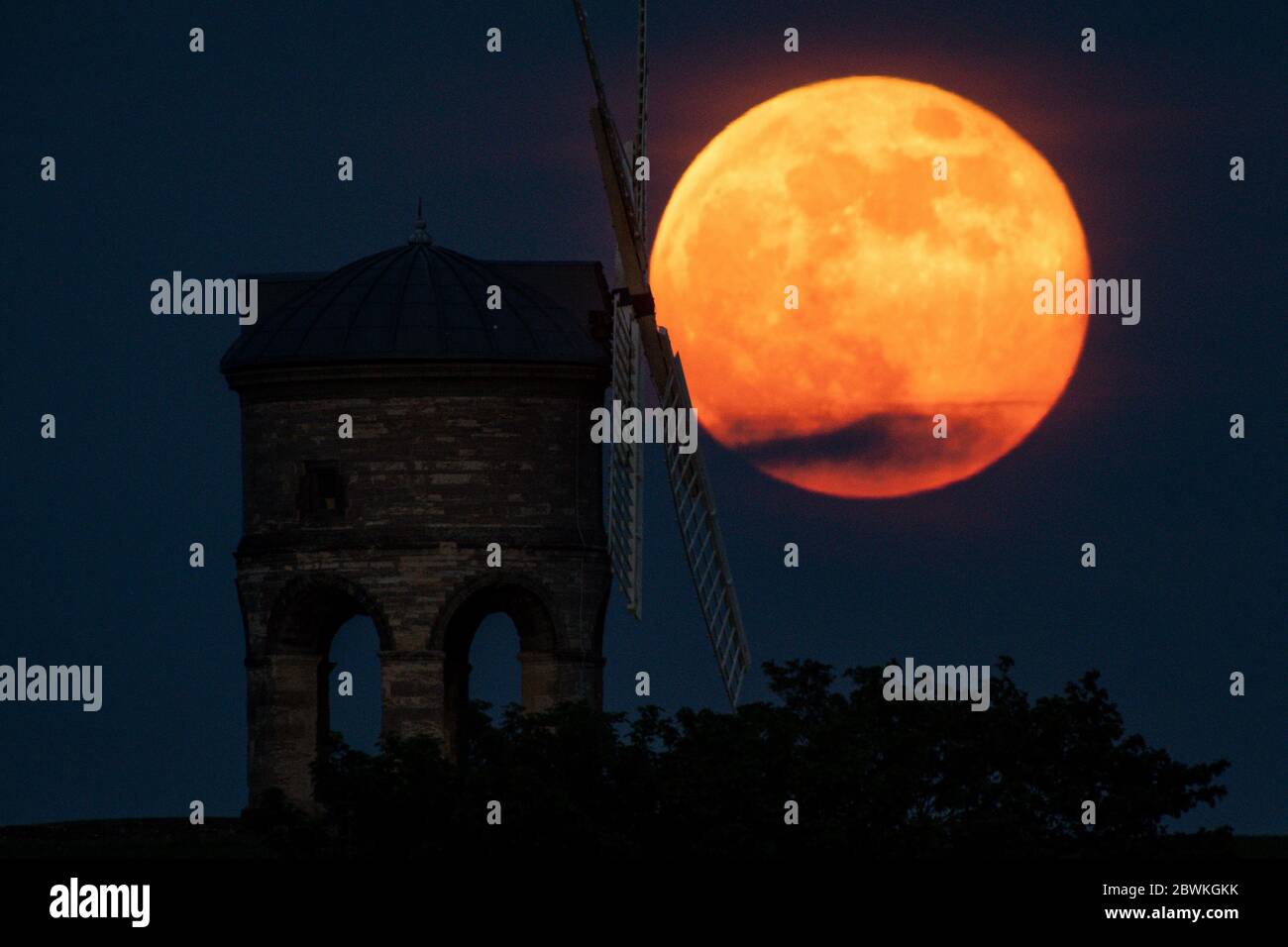 The full moon, also known as the Supermoon or Flower Moon, rises over Chesterton Windmill, Warwickshire. Stock Photo