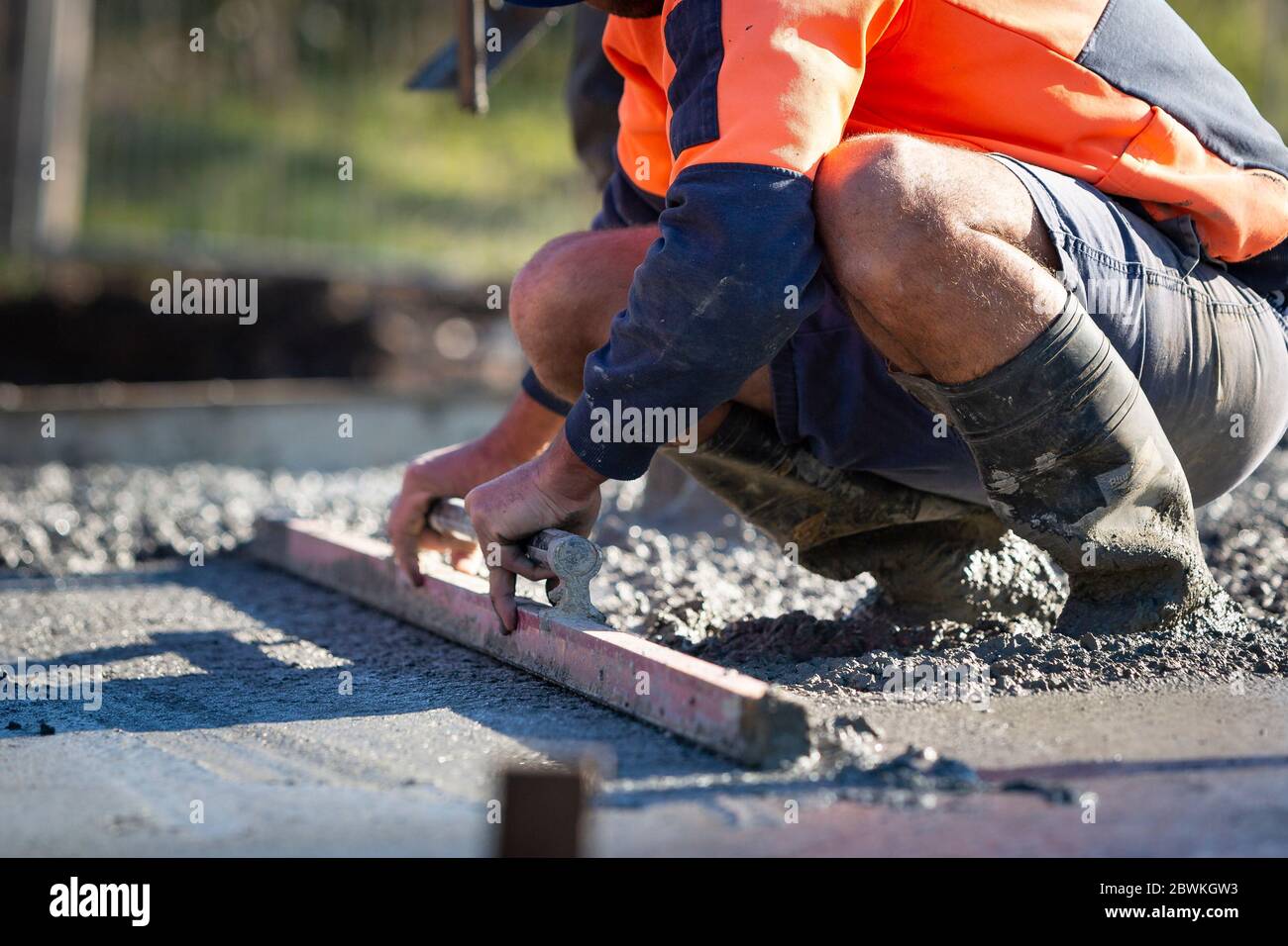 Pouring and leveling a new concrete slab for a residential house under