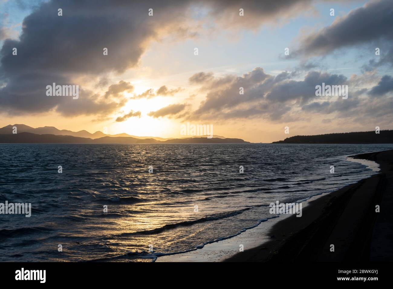 Sunset over misty mountain ranges at mouth of Kawhia harbour, Kawhia