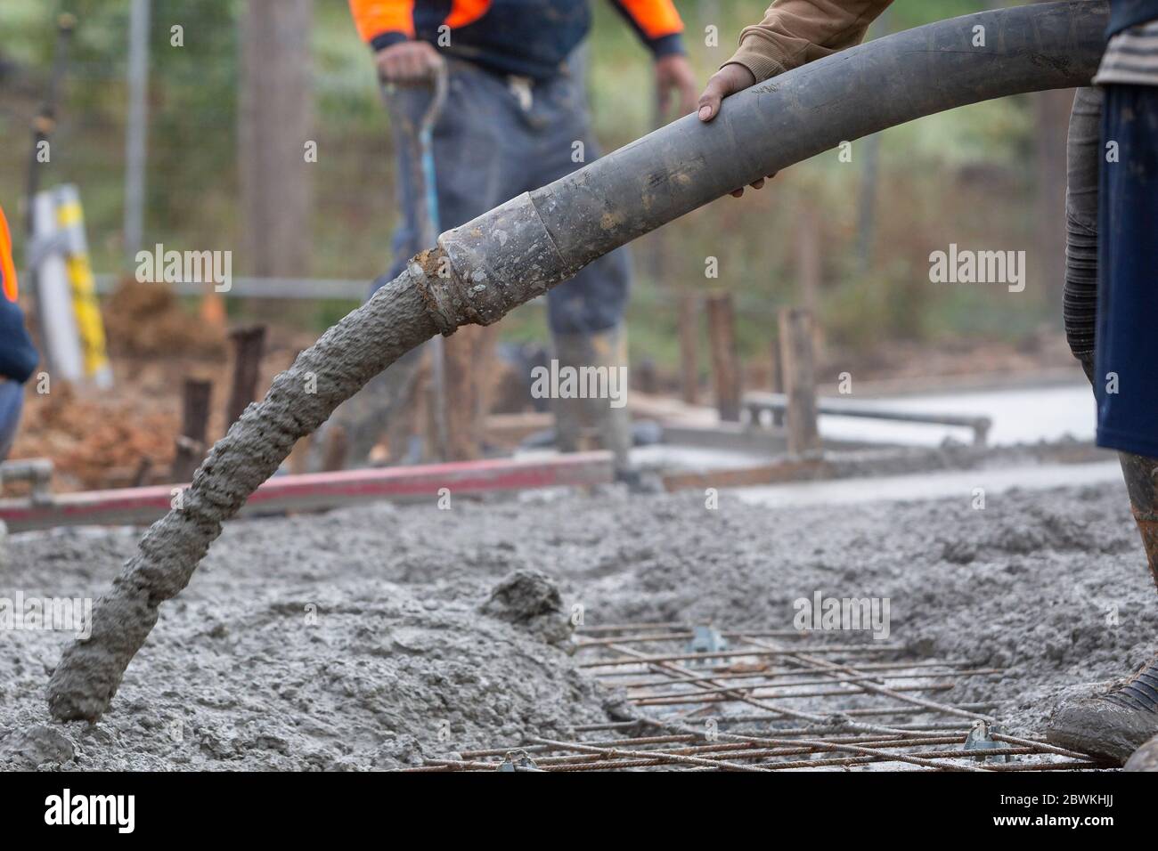 Pouring and leveling a new concrete slab for a residential house under construction in Melbourne Australia Stock Photo