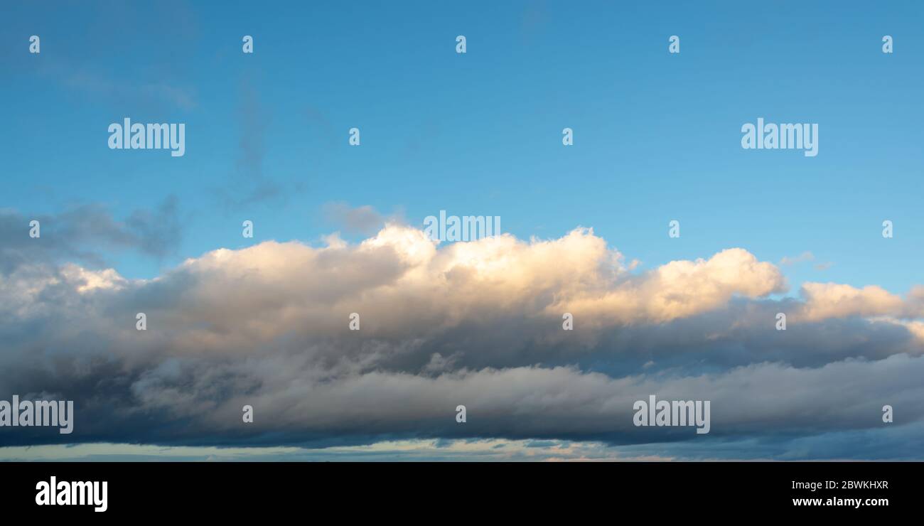 Low altitude stratocumulus cloud under a blue sky, panoramic nature background Stock Photo