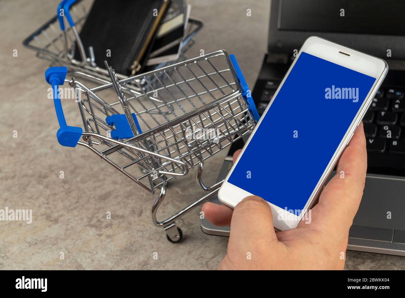 man orders a product on a cell phone. shopping cart. selective focus. online shopping Stock Photo