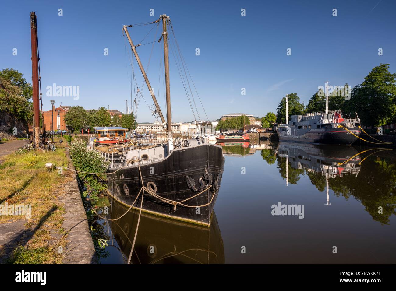 Bristol, England, UK - May 25, 2020: Early morning light shines on historic boats docked in Bristol's Floating Harbour. Stock Photo